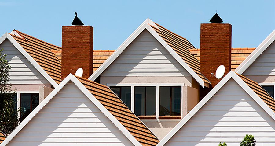 View of condo complex roofs and chimneys