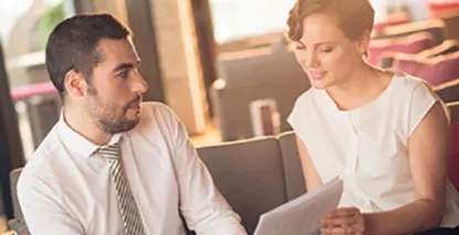 Two people looking at a shared document