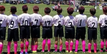 young soccer players standing on the field