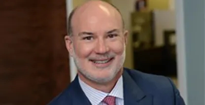 Dennis Abbott, FirstService Residential President, smiling at the camera