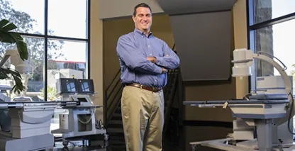 Chris Gleason, NextMed CEO, posing in a surgery suite