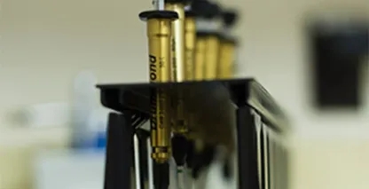 Syringes in a stand with liquid in them
