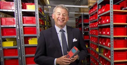 Brad Mountz, Chief Executive Officer, posing in the warehouse and smiling at the camera