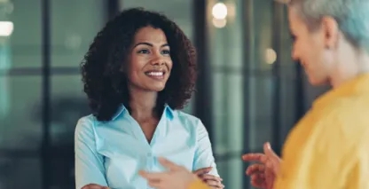 Business women smiling and talking with each other