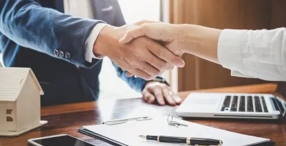 Close up of man and woman shaking hands.