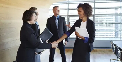 Business professionals shaking hands with their banker