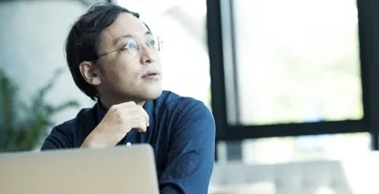 A small business owner sitting at his desk