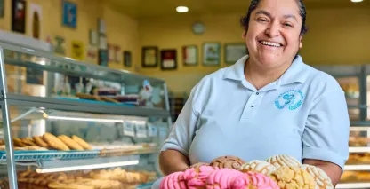 Woman holding a tray of pastries