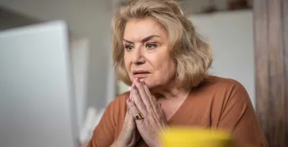 A woman on her laptop discovering she is the victim of email fraud