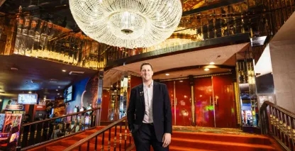 The CEO of the Plaza Hotel and Casino standing on the hotel lobby steps