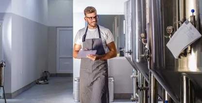 A production plant manager walking along a factory floor