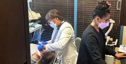 Two dentists at work in a dentists' office