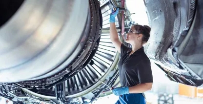 Woman working on an airplane engine