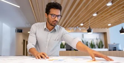 Man reviewing documents at an office desk