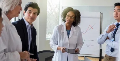 Healthcare professionals and business leaders meeting in a conference room, reviewing performance data