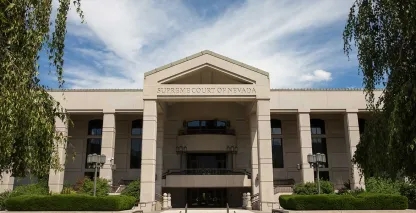 Supreme Court of Nevada building with columns and landscaped grounds under a blue sky