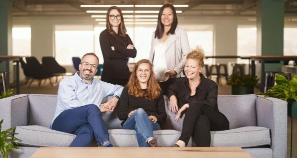 5 business professionals posing for a photo