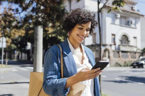 A woman opening a high-yield savings account on her mobile phone