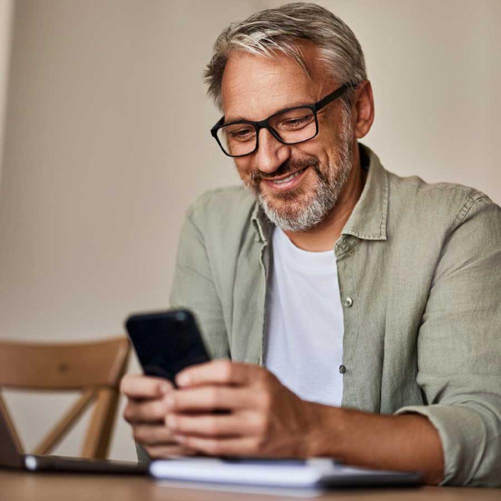 A man using a banking app on his mobile phone