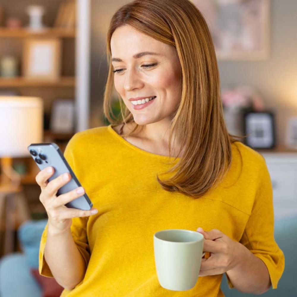 A woman using a banking app on her mobile phone