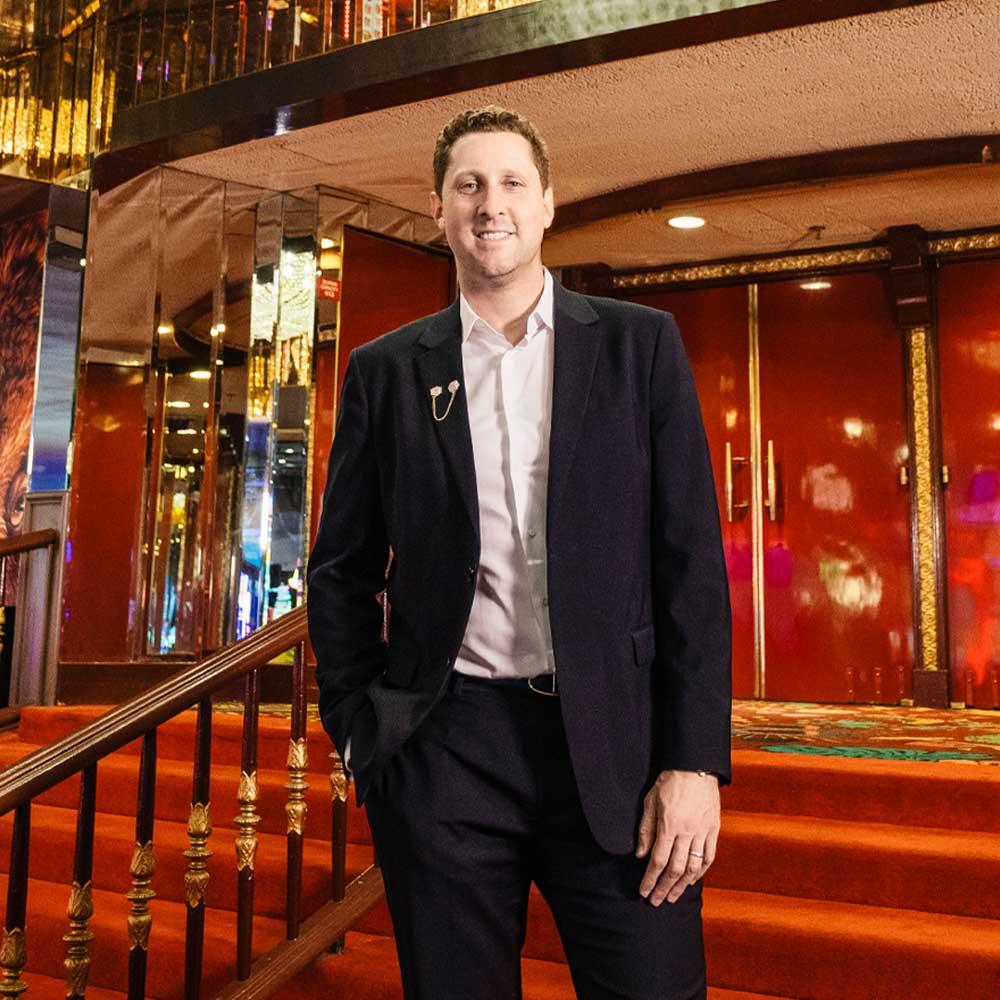 The CEO of the Plaza Hotel and Casino standing on the hotel lobby steps