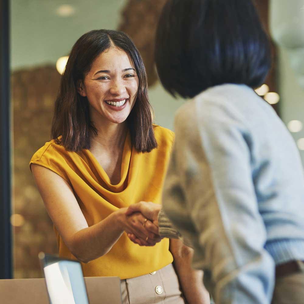 A small business relationship manager greeting a client 